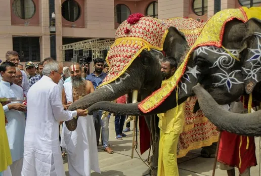 Lord Jagannath Temples head priest Mahant Dilipdas Maharaj pets elephants while offering prayers to them a day before the annual Rath Yatra of Lord Jagannath, in Ahmedabad, Thursday