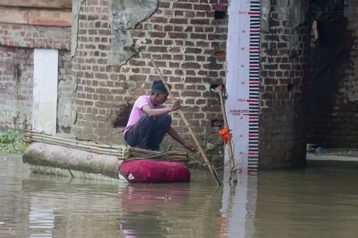 A man rows his improvised boat near the scale at the Yamuna River
