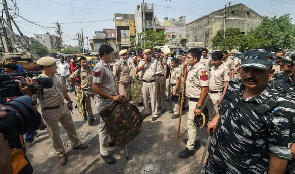 Delhi police personel keeping vigil in Jahangir Puri of Delhi after clashes between two groups