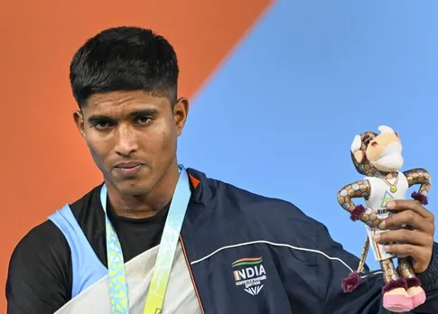  Indian weightlifter Sanket Sargar atop the podium poses for photos after winning the silver medal in the mens 55kg category weightlifting event, at the Commonwealth Games (CWG) 2022, in Birmingham