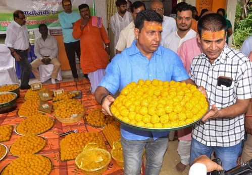 Members of Maharana Pratab Seva Foundation prepare laddoos to be distributed among locals to celebrate the oath-taking ceremony of President-elect Droupadi Murmu, in Ranchi