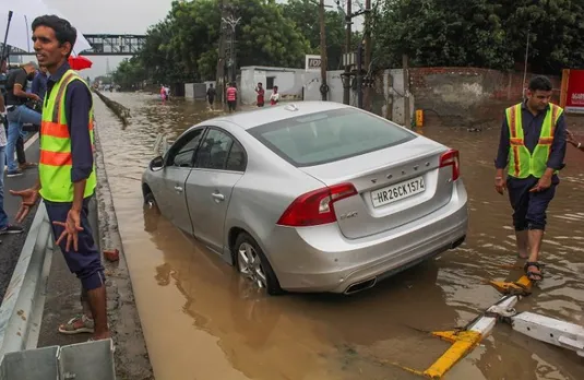 A vehicle stuck on the waterlogged road