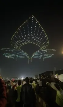 Drone light show over Navi Mumbai International Airport watched by construction workers and staff before commercial opening