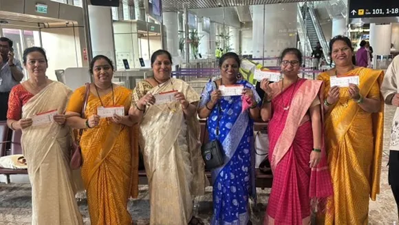 Workers, first-time flyers and veterans walking together through NMIA terminal during its people-first opening