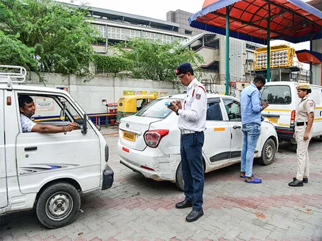 A Delhi traffic police official checks the validity of a vehicle (Photo/ANI)