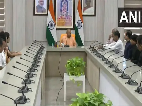 UP CM Yogi Adityanath interacts with newly promoted IAS officers in Lucknow (Photo/ANI)