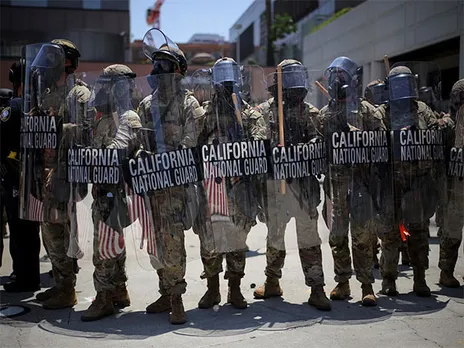 Members of the California National Guard carry shields during a protest (File Photo/Reuters)