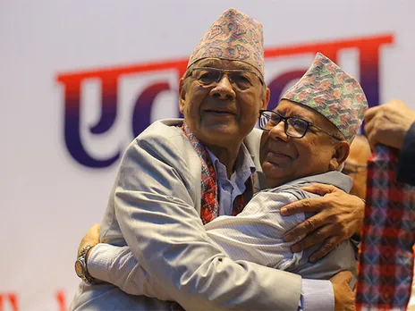 Former Prime Minister and Chairman of CPN-Unified Socialist Madhav Kumar Nepal (Right) hugs former Home Minister and chairman of CPN Unity National Campaign Bamdev Gautam (Left) following the unification announcement of two splinter communist parties in Kathmandu on 18 July (Photo/ANI)
