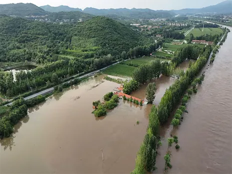 A drone view shows flooded farmlands next to the overflowing Chao river, following heavy rainfall in Miyun district of Beijing (Image/Reuters)