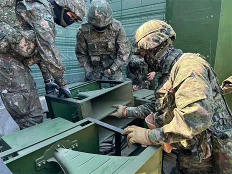 South Korean soldiers work on a loudspeaker that is set up for propaganda broadcasts (Image/Reuters)