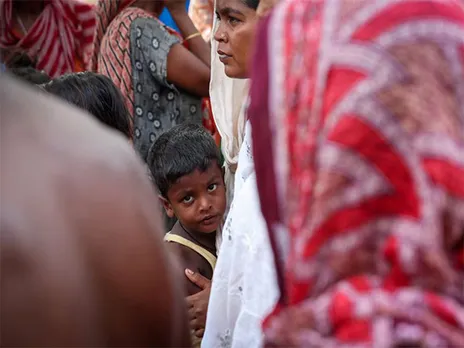 A boy stands with his mother inside a makeshift shelter (File Image/Reuters)