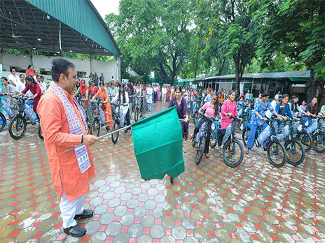 Rajasthan Chief Minister Bhajanlal Sharma distributing e-cycles to girls and working women (Photo/ANI)