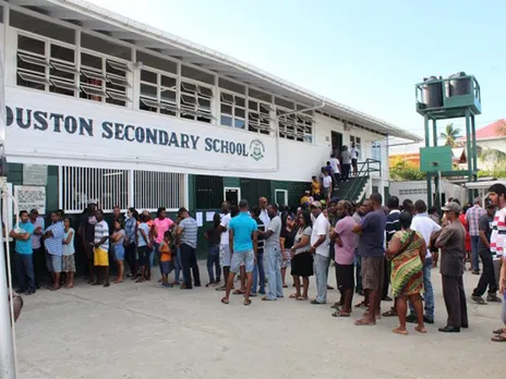 People line up to cast their votes in Guyana’s presidential elections in Georgetown (Photo/Reuters)