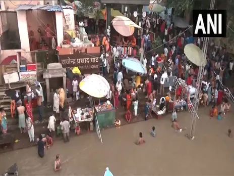 Varanasi: Devotees take holy dip in River Ganga after total lunar eclipse. (Photo/ANI)
