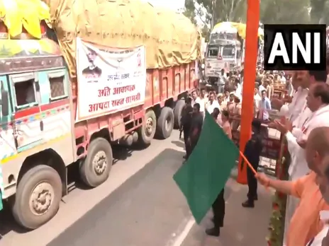 UP CM Yogi flags of 48 trucks of relief materials to flood-affected states (Photo/ANI)
