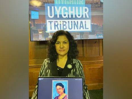 Rushan Abbas, Founder and Executive Director of the Campaign for Uyghurs, holds a picture of her sister Dr Gulshan Abbas, imprisoned in China (Image: X/@RushanAbbas)