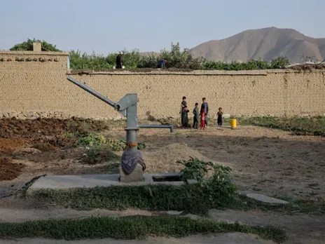 Children stand beside a dried-up hand pump amid a worsening water crisis in Kabul, Afghanistan. (File Photo/Reuters)