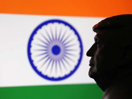 A 3D-printed miniature model of US President Donald Trump is seen alongside the Indian flag in this illustration. (Photo/Reuters)