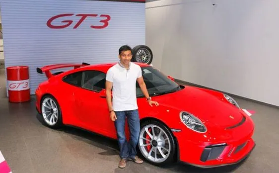 Formula One racer Narain Karthikeyan takes keys of his new Porsche 911 GT3