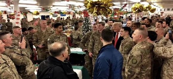 Donald Trump makes surprise visit to US troops in Iraq, defends Syria withdrawal
