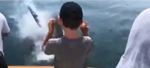 Watch: Shark jumps out of water, snatches fish from rod just inches away from little boy