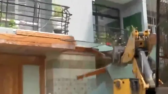 Bulldozer demolishing encroached area of Shrikant Tyagi flat