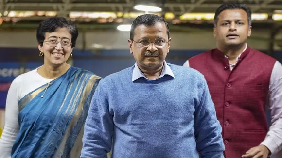 atishi with arvind kejriwal