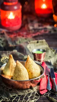 fried-samosa-with-green-dip-on-old-wooden-table-2025-03-24-07-38-57-utc