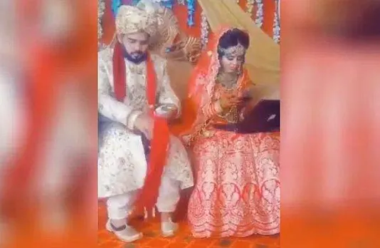 കല്യാണദിവസവും ലീവില്ല;  ഭര്‍ത്താവിനൊപ്പം വിവാഹ വേദിയിലിരിക്കുമ്പോഴും വധു വര്‍ക്ക് ഫ്രം ഹോമില്‍!; കയ്യില്‍ ലാപ്പുടോപ്പുമായി ജോലി ചെയ്യുന്ന ചിത്രം വൈറല്‍