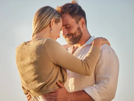 A couple holding each other, standing together 