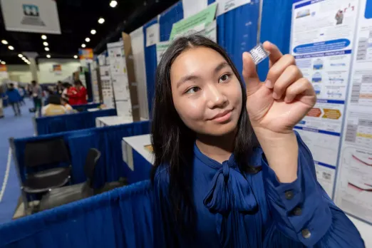 Chris Ayers/Society for Science,Grace Sun holds an OECT device that helped her win the ISEF science fair.   