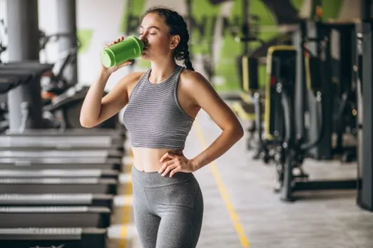 women drinking protein
