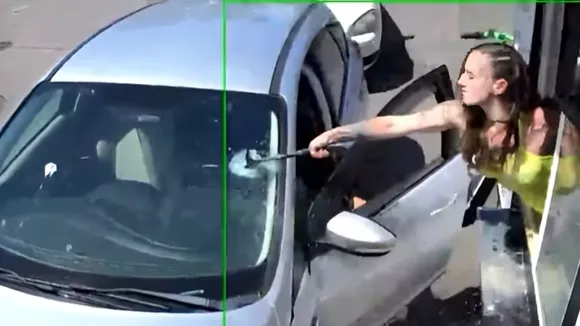 woman shatters car window of rude customer.png