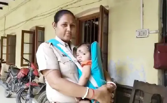 assam cop viral photo, assam woman cop carries child to work