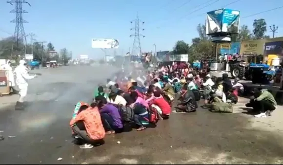 migrants sprayed disinfectant