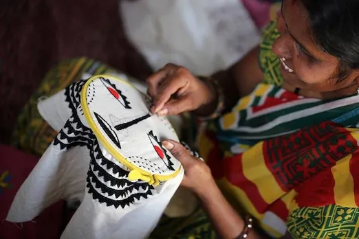 Women embroiders at skills camp
