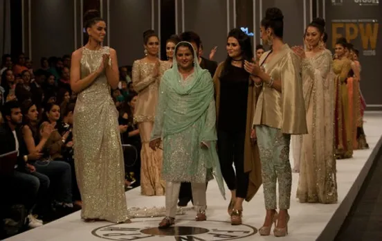 Pakistan's gang rape victim Mukhtar Mai walks on to stage during a fashion show in Karachi, Pakistan