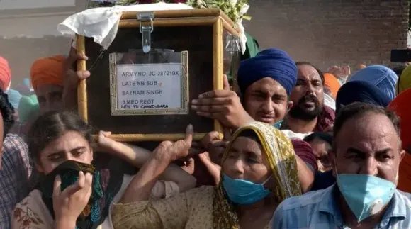 mother carries coffin