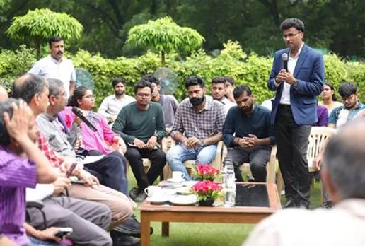 A person speaking into a microphone in front of a group of peopleAI-generated content may be incorrect.