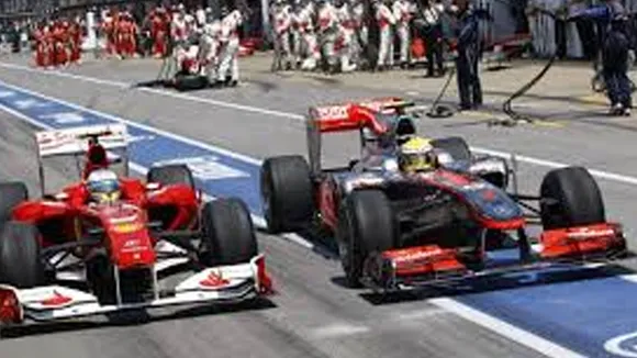 Fernando Alonso and Lewis Hamilton in pit lane 