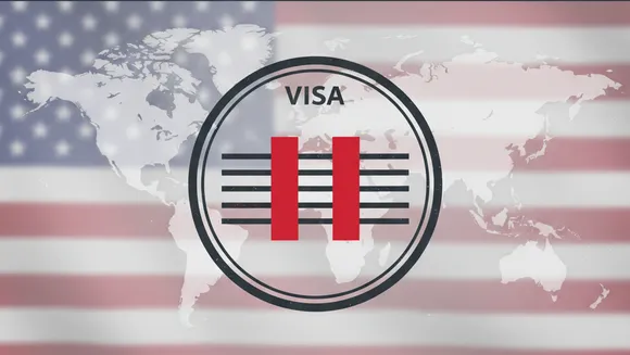 Editorial graphic showing a US visa stamp with a pause symbol, representing the US decision to pause green card processing for applicants from 75 countries.