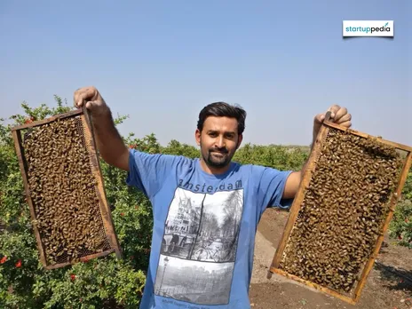 Founder of Amar Honey, Mr. Brijesh Kalariya, holding beehives.