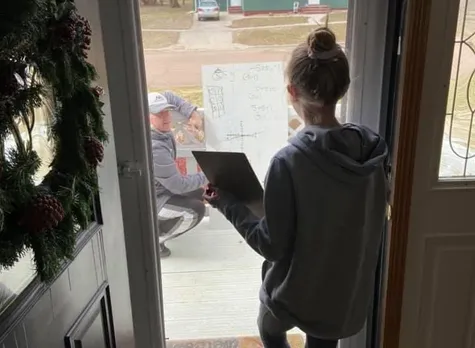 Math teacher solving doubts of a student at her house porch