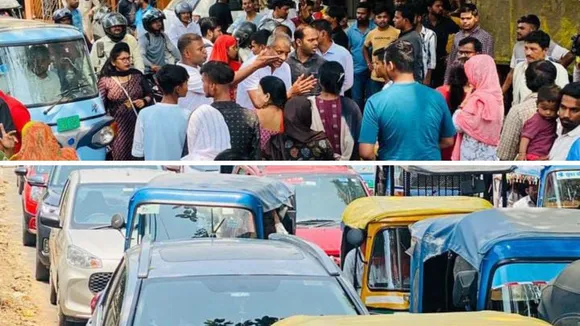 शराब ठेके के विरोध में हंगामा करते लोग और जाम लगाए जाने से सड़क पर लगीं वाहनों की कतारें।
