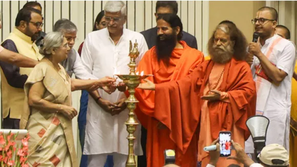 Union Minister Gajendra Singh Shekhawat, yoga guru Ramdev, Pujya Swami Chidanand Saraswati, Union Minister Prataprao Jadhav, and others light a lamp during the inaugural session of ‘Yoga Connect’ at Vigyan Bhawan 