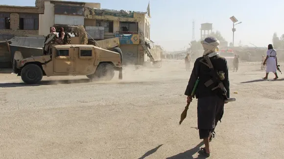 Afghan Taliban fighters patrol near the Afghanistan-Pakistan border