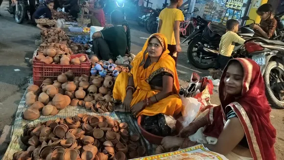 बहादुर गंज में फुटपाथ पर दीया बिक्री करती माटी कलाकार महिलाएं
