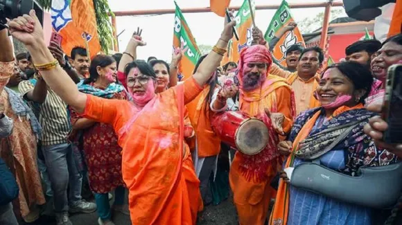 BJP supporters celebrate at the party office in Patna