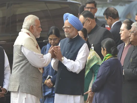 New Delhi: Prime Minister Narendra Modi greets his predecessor Manmohan Singh as they arrive to pay tributes to the martyrs of 2001 Parliament attack in New Delhi on Dec 13, 2017. (File Photo: IANS)
