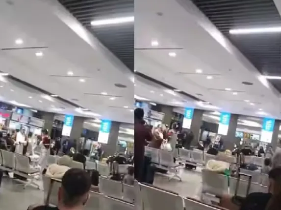 Woman and cleric at Tehran airport (Photo- X/Video grab)